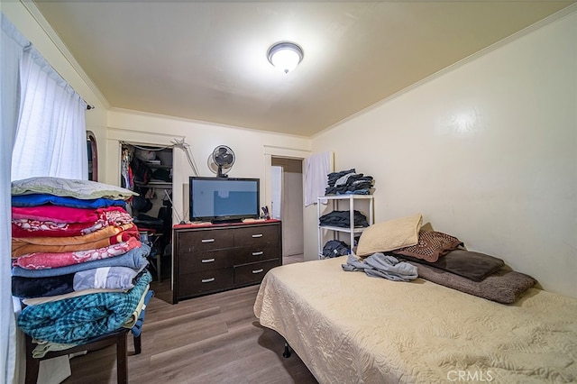 bedroom featuring crown molding and hardwood / wood-style floors