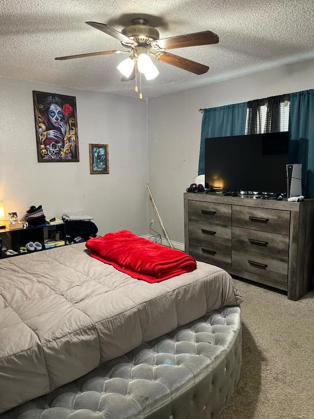 carpeted bedroom with a textured ceiling and ceiling fan