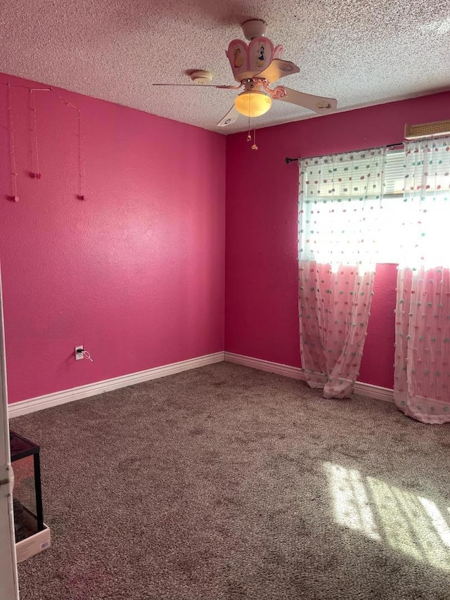 empty room with carpet, a textured ceiling, and a wealth of natural light