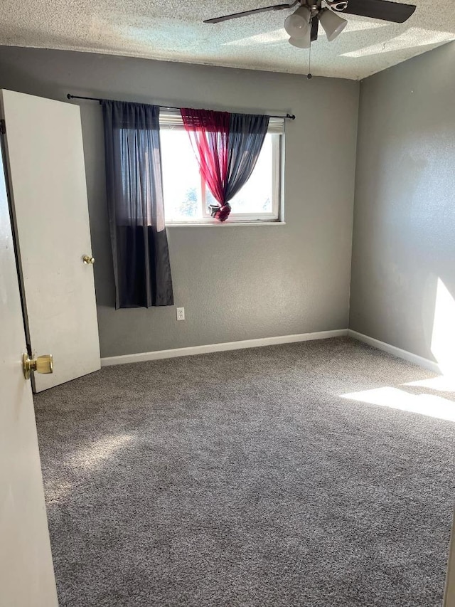 unfurnished room with a textured ceiling, carpet floors, and ceiling fan