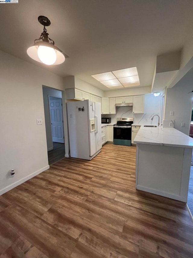 kitchen featuring white cabinets, kitchen peninsula, stainless steel electric range, dark hardwood / wood-style floors, and white refrigerator with ice dispenser