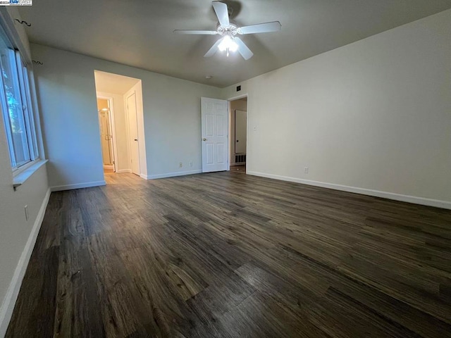 unfurnished bedroom featuring dark wood-type flooring and ceiling fan