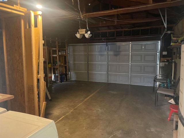 garage featuring a garage door opener and washer / dryer