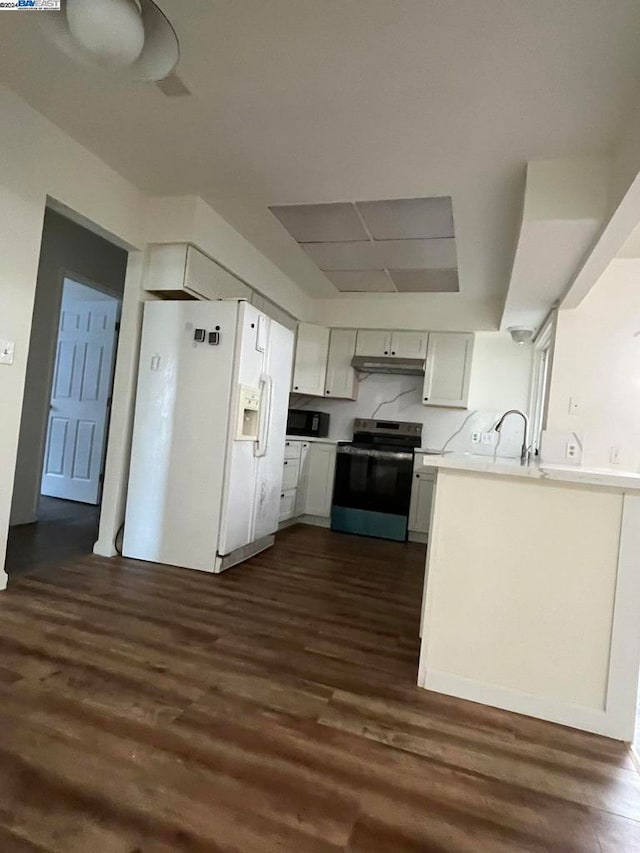 kitchen featuring electric stove, white refrigerator with ice dispenser, white cabinets, and dark wood-type flooring