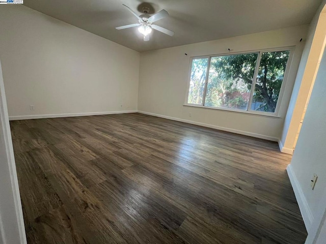 empty room with dark wood-type flooring and ceiling fan