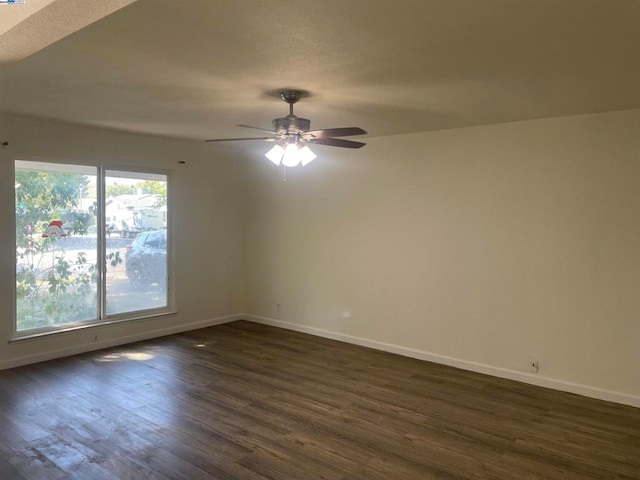 spare room with ceiling fan and dark wood-type flooring