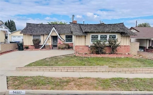 14557 Allegan St, Whittier, CA 90604 - view of front of property with board and batten siding, a chimney, a front lawn, and brick siding