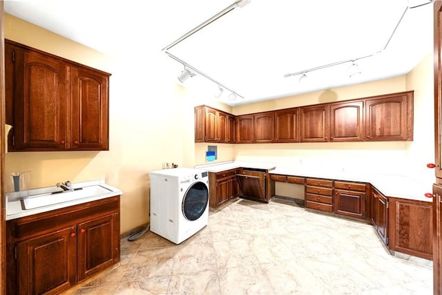 laundry room with cabinets, sink, and washer / clothes dryer