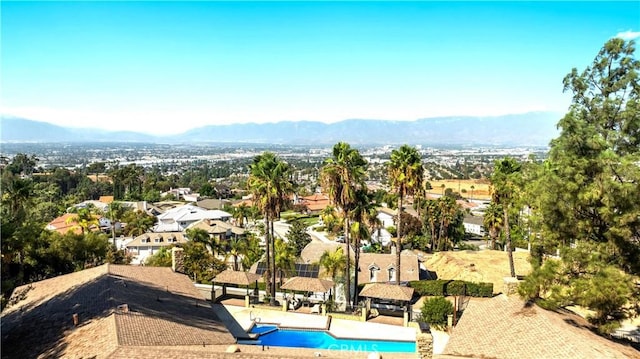 birds eye view of property with a mountain view