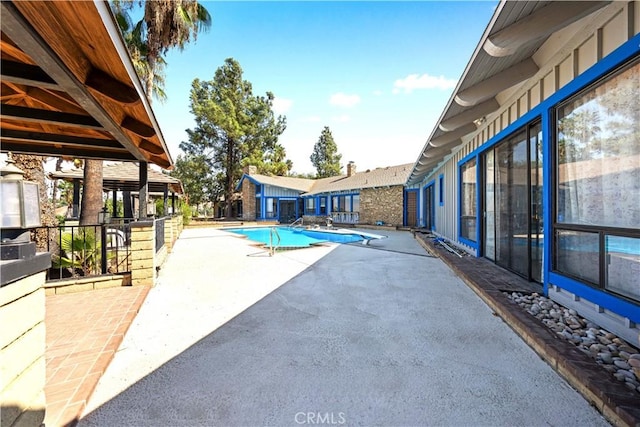 view of swimming pool with a patio area