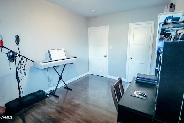 office with dark hardwood / wood-style flooring