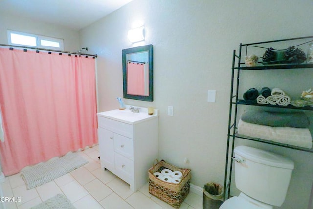 bathroom featuring tile patterned flooring, vanity, a shower with shower curtain, and toilet