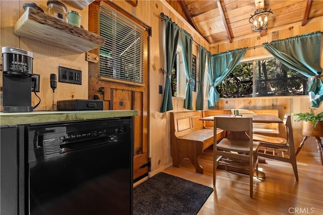 interior space featuring vaulted ceiling, wooden walls, black dishwasher, hardwood / wood-style flooring, and wooden ceiling