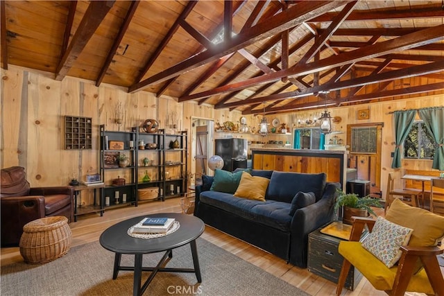 living room featuring lofted ceiling with beams, light hardwood / wood-style floors, wood ceiling, and wood walls