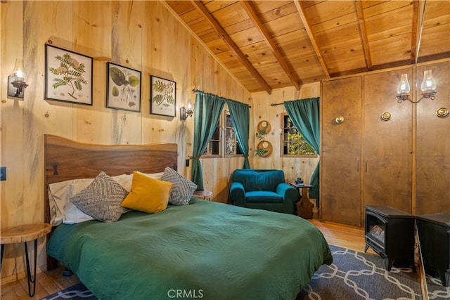 bedroom with wood walls, wood ceiling, lofted ceiling with beams, a wood stove, and hardwood / wood-style floors