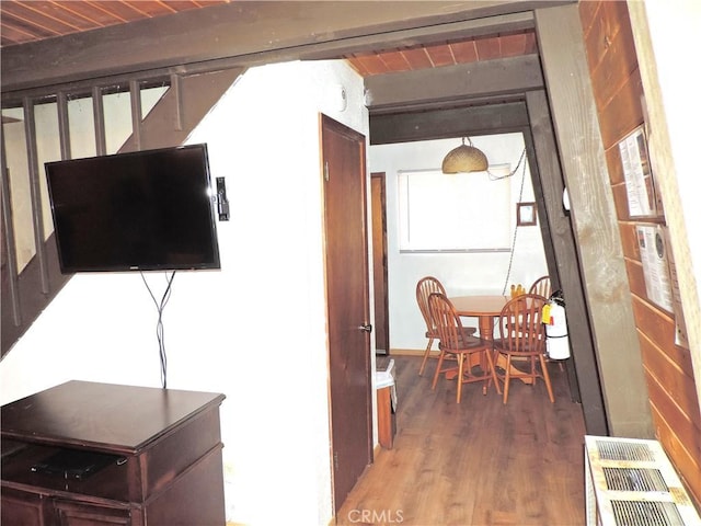 hall with beam ceiling, wood-type flooring, and wooden ceiling