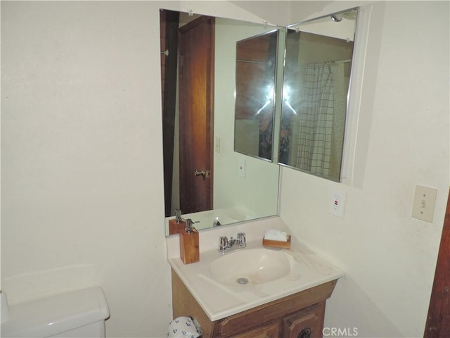 bathroom featuring vanity and toilet