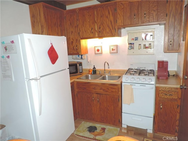 kitchen featuring white appliances and sink