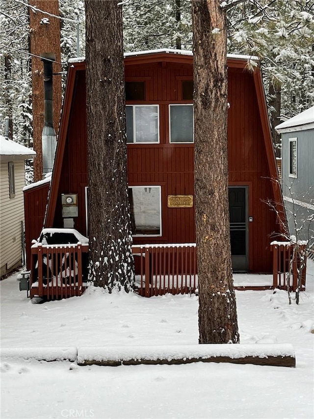 view of snow covered rear of property