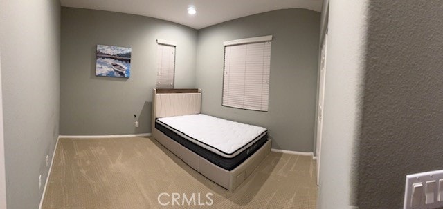 bedroom featuring light colored carpet