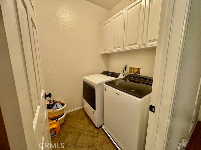 laundry area featuring independent washer and dryer and cabinets