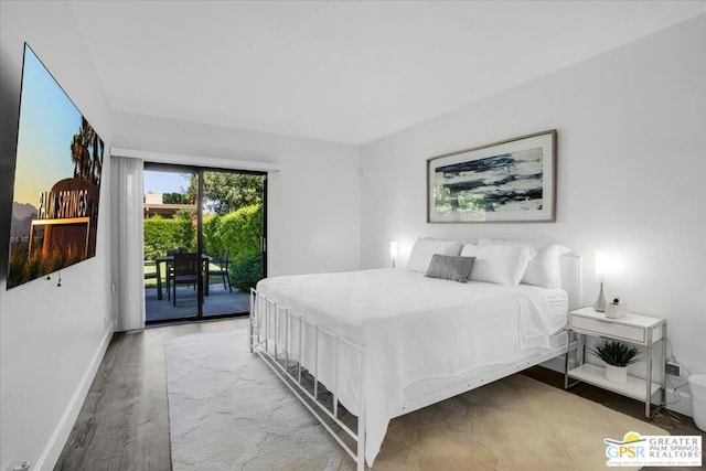 bedroom featuring access to exterior and wood-type flooring