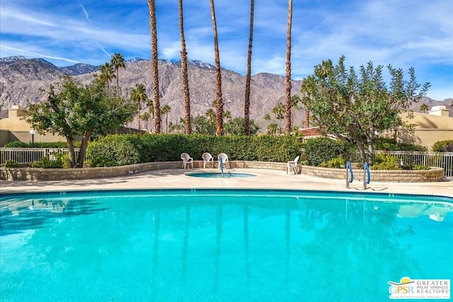 view of swimming pool with a mountain view