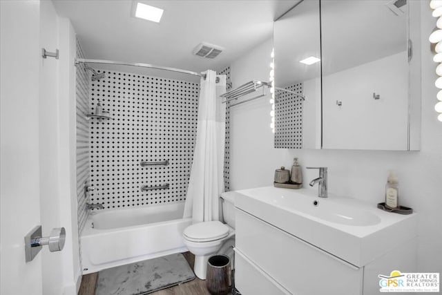 full bathroom featuring hardwood / wood-style flooring, shower / bath combo, toilet, and vanity