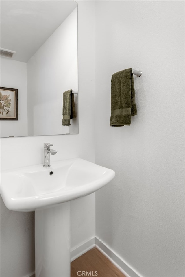 bathroom with sink and wood-type flooring