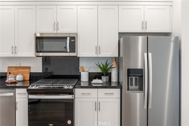 kitchen with white cabinets, decorative backsplash, and stainless steel appliances