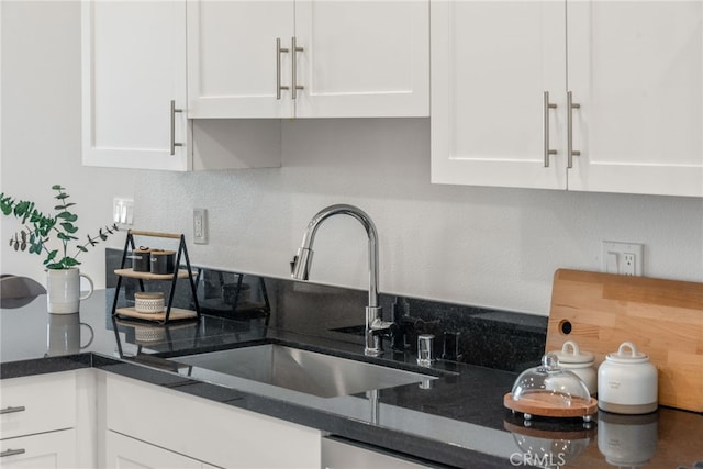 kitchen featuring white cabinets and sink