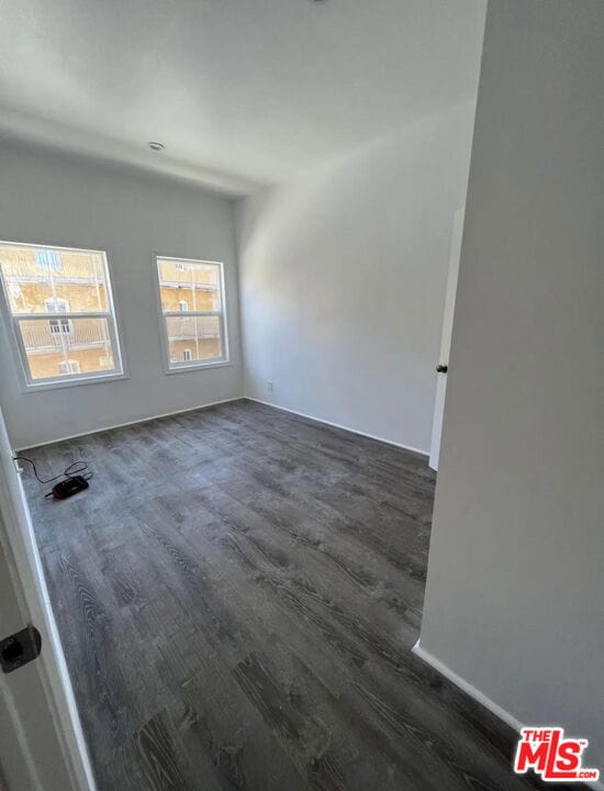 spare room featuring dark hardwood / wood-style floors