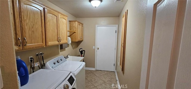 laundry room featuring a sink, cabinet space, independent washer and dryer, and light tile patterned flooring