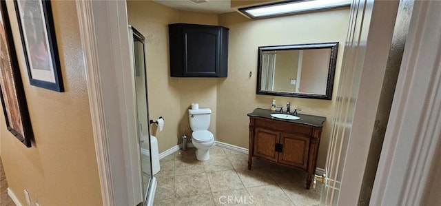 bathroom featuring vanity, tile patterned floors, toilet, and baseboards