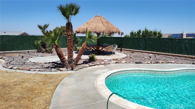 view of pool with a fenced in pool, a fenced backyard, and a patio area