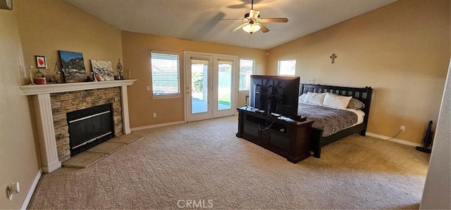 bedroom featuring access to outside, a stone fireplace, carpet, and vaulted ceiling