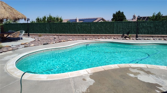 view of swimming pool with a patio area, a fenced backyard, and a fenced in pool