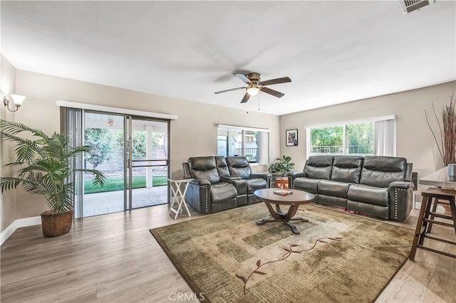 living room featuring ceiling fan and hardwood / wood-style floors