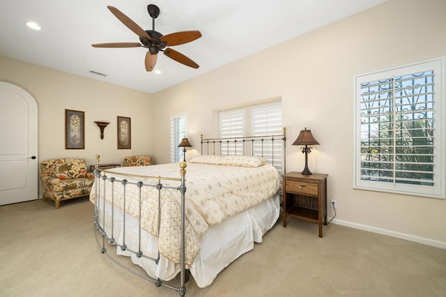 carpeted bedroom with ceiling fan and multiple windows