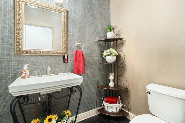 bathroom with tile walls and toilet