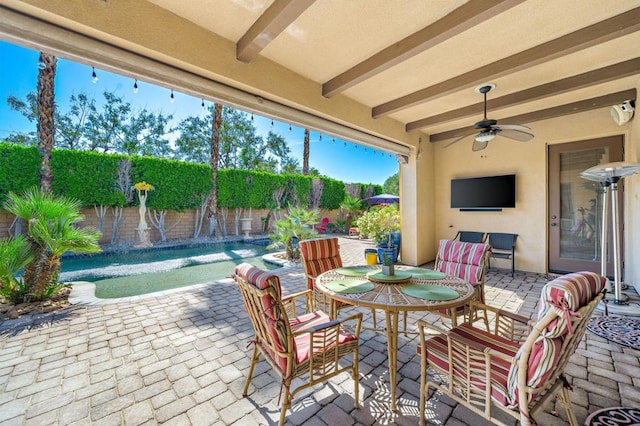 view of patio featuring pool water feature, a fenced in pool, and ceiling fan