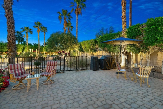 view of patio terrace at dusk