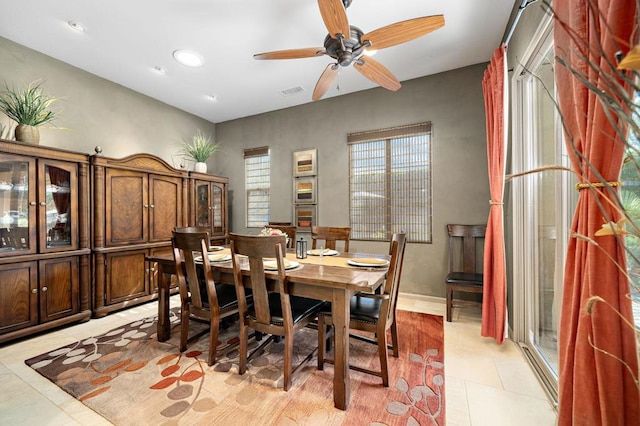 tiled dining area with ceiling fan