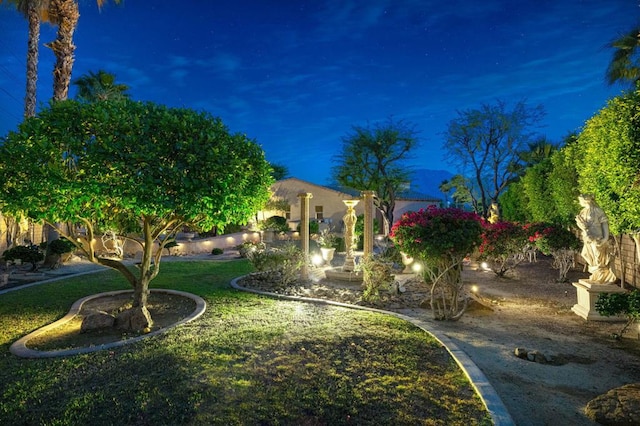 view of yard at twilight