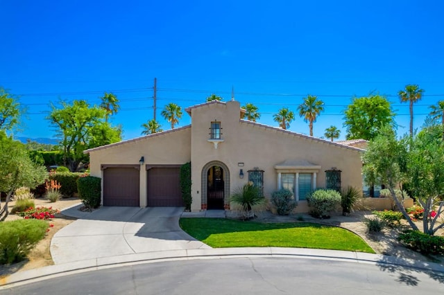 mediterranean / spanish-style house with a garage