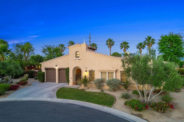 mediterranean / spanish house featuring a garage