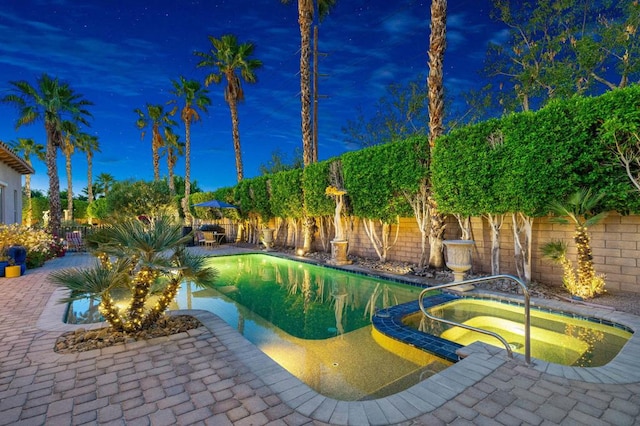 view of pool with an in ground hot tub