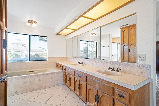 bathroom featuring tile patterned floors, vanity, and separate shower and tub