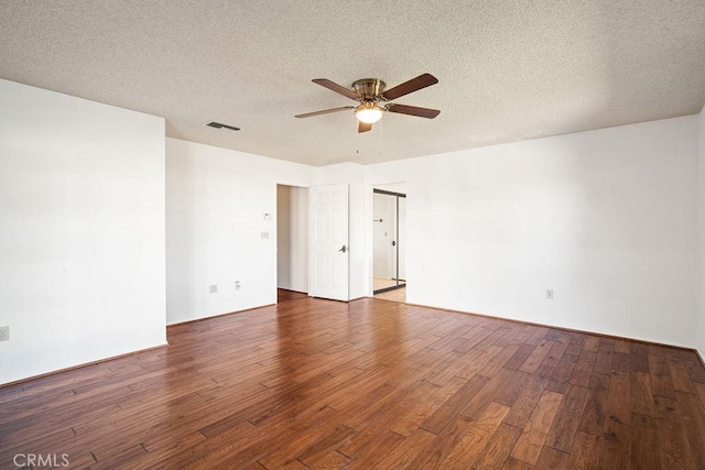 unfurnished room featuring hardwood / wood-style flooring, ceiling fan, and a textured ceiling