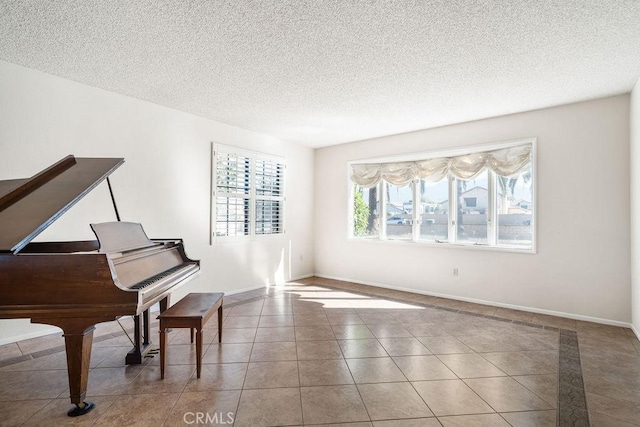 miscellaneous room with a textured ceiling and light tile patterned floors